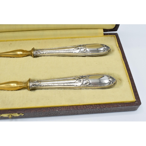 123 - A cased pair of late 19th century silver and gilt metal salad servers, probably European, with indis... 