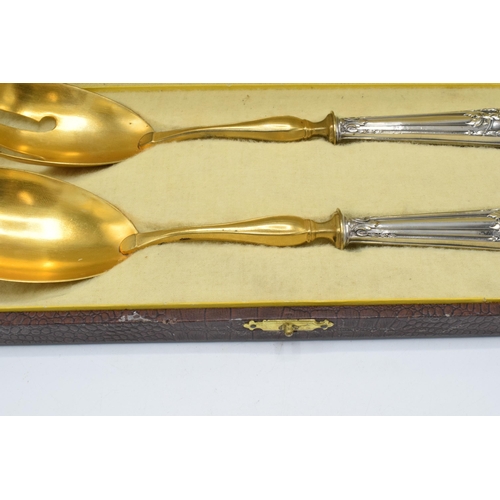 123 - A cased pair of late 19th century silver and gilt metal salad servers, probably European, with indis... 