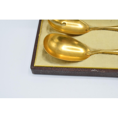 123 - A cased pair of late 19th century silver and gilt metal salad servers, probably European, with indis... 