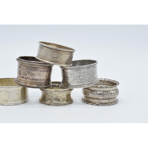 126 - A collection of hallmarked silver napkin rings of varying ornate designs, 76.0 grams (6).