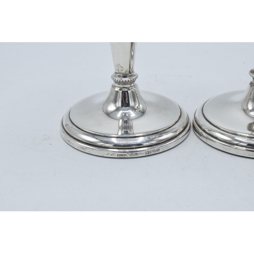 156 - A near pair of hallmarked silver candlesticks, made by W I Broadway & Co, Birmingham 1984 and 1989, ... 