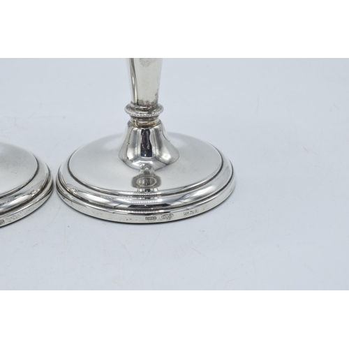 156 - A near pair of hallmarked silver candlesticks, made by W I Broadway & Co, Birmingham 1984 and 1989, ... 