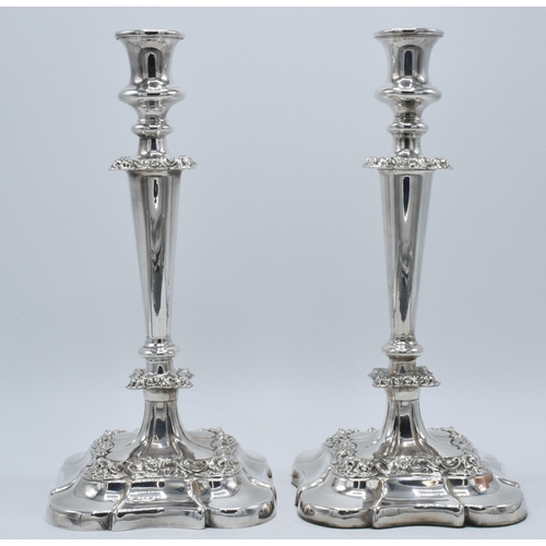 157 - A pair of silver plated large candlesticks with embossed floral decoration, 31.5cm tall (2).