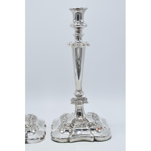 157 - A pair of silver plated large candlesticks with embossed floral decoration, 31.5cm tall (2).