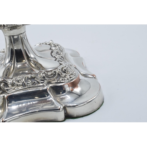 157 - A pair of silver plated large candlesticks with embossed floral decoration, 31.5cm tall (2).