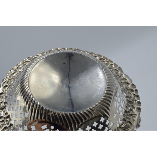 161 - Silver sweet dish with repousse and pierced decoration, 36.4 grams, Chester 1897, 12cm diameter.