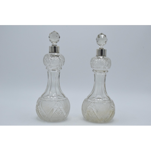 184 - A pair of silver collared glass perfume bottles, London, circa 1925, 22cm tall (2), hallmarks rubbed... 