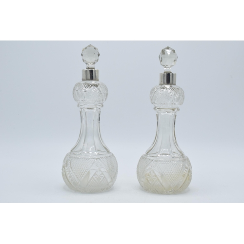 184 - A pair of silver collared glass perfume bottles, London, circa 1925, 22cm tall (2), hallmarks rubbed... 