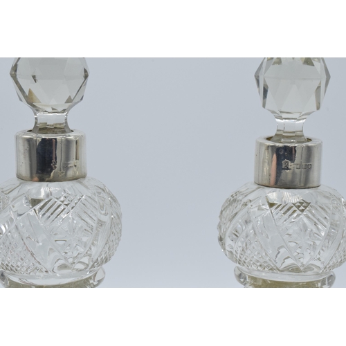 184 - A pair of silver collared glass perfume bottles, London, circa 1925, 22cm tall (2), hallmarks rubbed... 