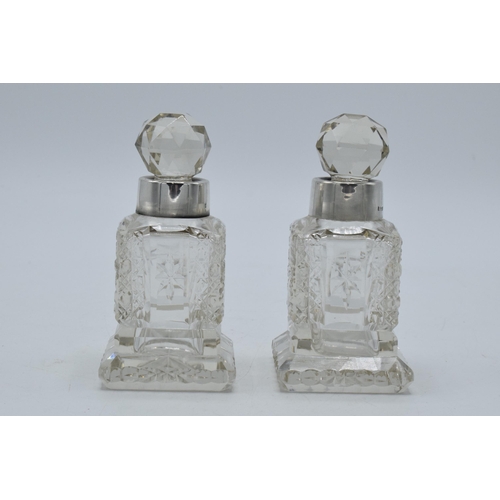 193 - A pair of silver collared glass perfume bottles, Birmingham 1908, H C Davis, 10cm tall (2).