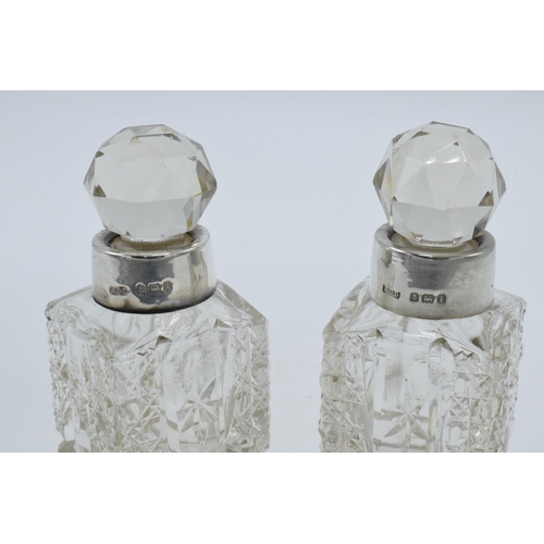 193 - A pair of silver collared glass perfume bottles, Birmingham 1908, H C Davis, 10cm tall (2).