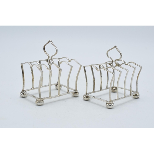 197 - A pair of silver toast racks with each having space for 4 slices, Birmingham 1925, Adie Bros, 73.0 g... 