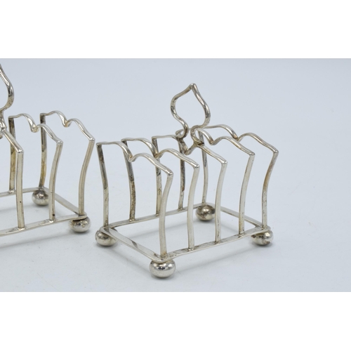 197 - A pair of silver toast racks with each having space for 4 slices, Birmingham 1925, Adie Bros, 73.0 g... 