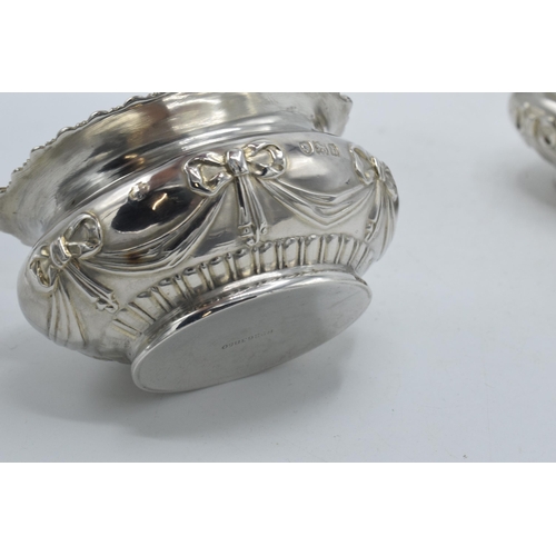 199 - A pair of silver table salts with embossed decoration of a bow and similar, London 1897, 80.4 grams,... 