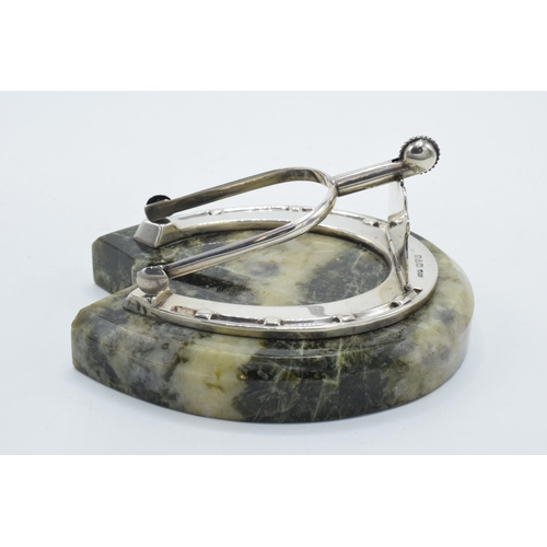 203 - Samson Mordan: a silver paper clip / holder in the form of a horseshoe mounted onto a hardstone / ag... 