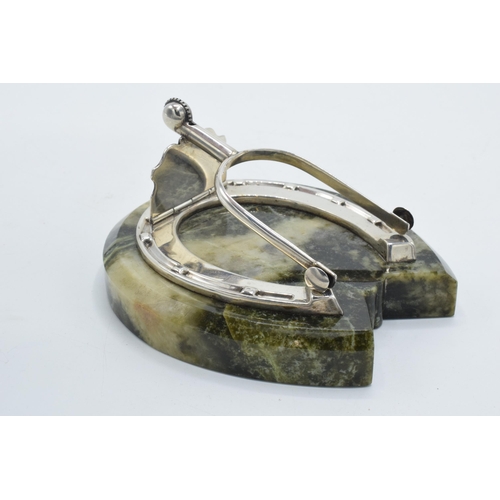 203 - Samson Mordan: a silver paper clip / holder in the form of a horseshoe mounted onto a hardstone / ag... 