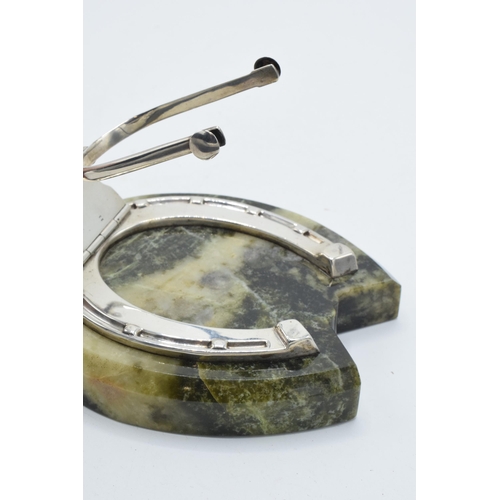 203 - Samson Mordan: a silver paper clip / holder in the form of a horseshoe mounted onto a hardstone / ag... 