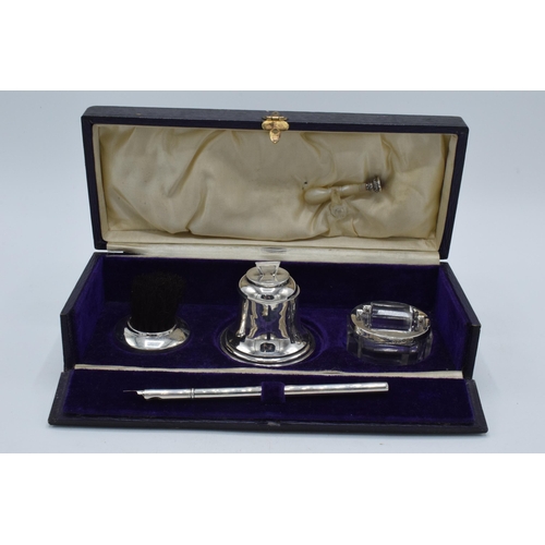 204 - Cased silver writing travelling set to include an inkwell, a brush, a stamp, a roller and an associa... 