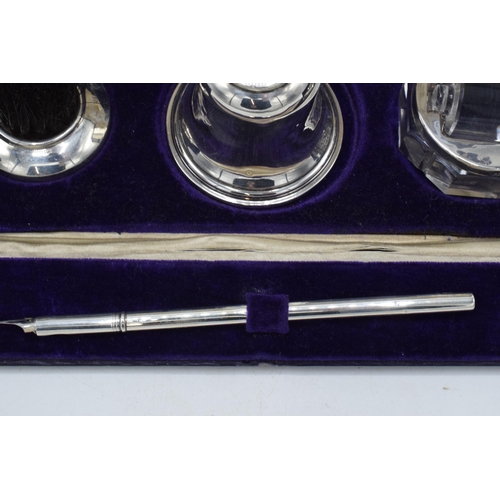 204 - Cased silver writing travelling set to include an inkwell, a brush, a stamp, a roller and an associa... 