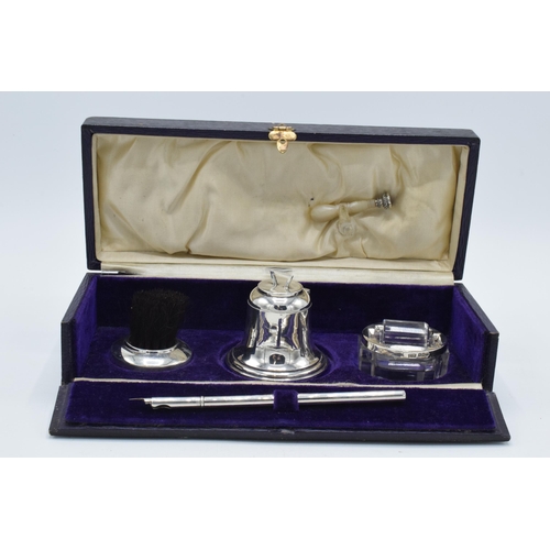 204 - Cased silver writing travelling set to include an inkwell, a brush, a stamp, a roller and an associa... 