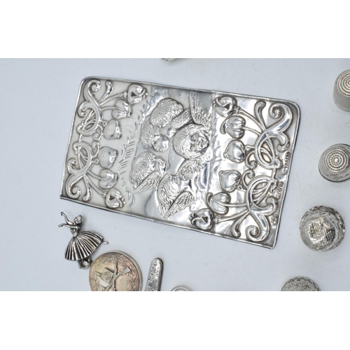 211 - A collection of silver items to include a sterling silver cased corkscrew, a silver Reynold's Angels... 