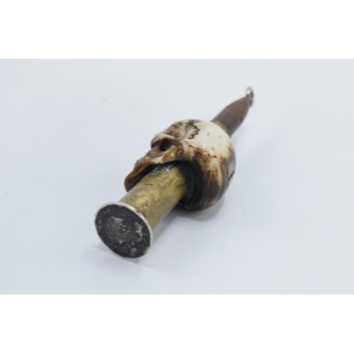 248 - Vintage Trench Art of a carved bone in the form of a skull with an ammunition shell, 9cm tall, mount... 