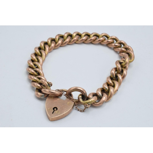 316 - 9ct rose gold hollow curb bracelet with heart-shaped padlock, 22.4 grams.