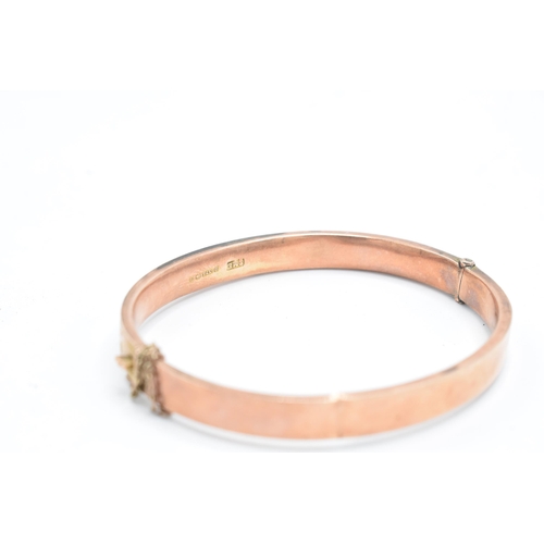 318 - 9ct rose gold bangle with engraved decoration, 8.8 grams, split to rear, 65mm diameter.