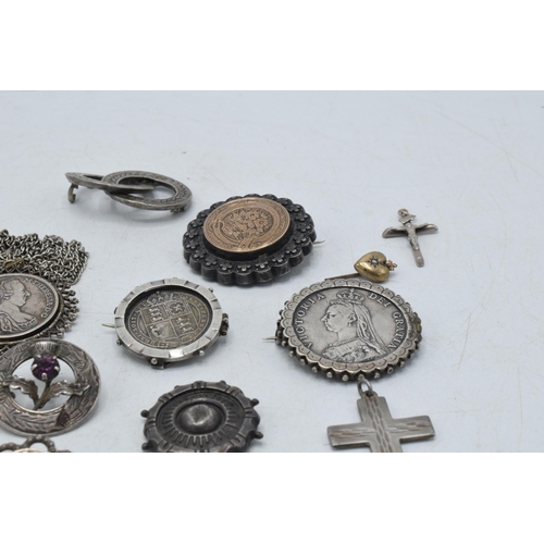 330 - A collection of silver and silver coloured jewellery to include Victorian coin brooches, a cross pen... 