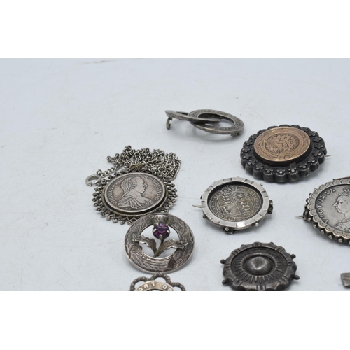 330 - A collection of silver and silver coloured jewellery to include Victorian coin brooches, a cross pen... 