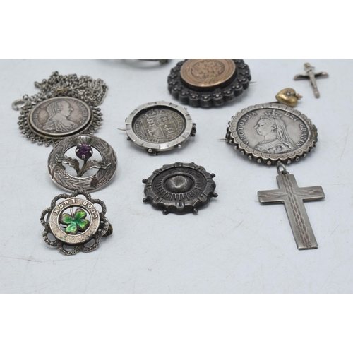 330 - A collection of silver and silver coloured jewellery to include Victorian coin brooches, a cross pen... 