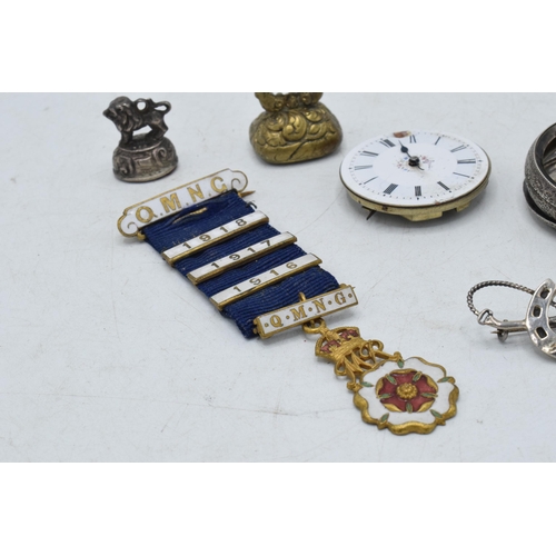 332 - A collection of items to include a white metal chain fob / seal, a brass example, silver riding crop... 