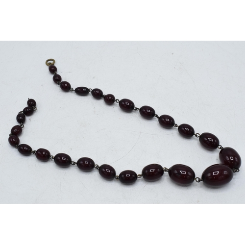 337 - A set of graduated cherry amber (or similar) beads with metal mounts, gross weight 25.4 grams, 43cm ... 