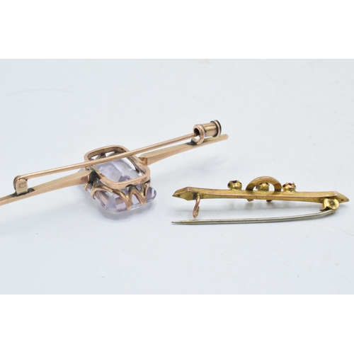 338 - A pair of 9ct gold bar brooches, one with a horseshoe set with garnets, base metal pin, together wit... 