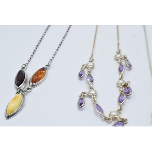 382 - A trio of silver ladies necklaces with pendants to include amber-style items and amethyst coloured s... 