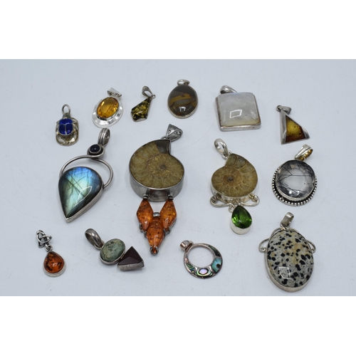 383 - An interesting collection of silver pendants with various gemstones and similar materials of varying... 