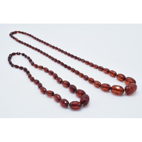 388 - A pair of vintage bakelite cherry amber (or similar) graduated necklaces with faceted beads, longest... 