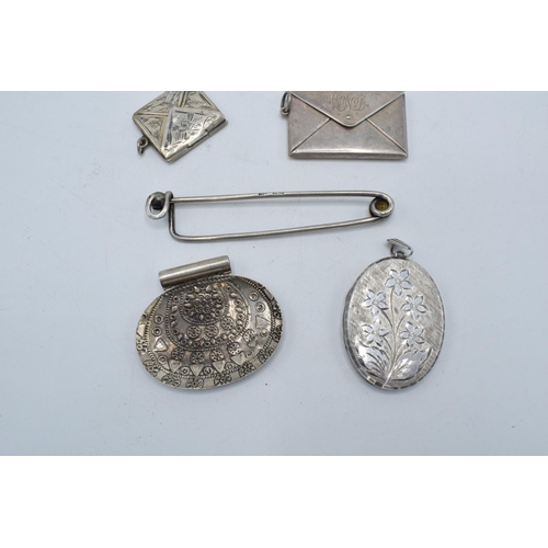 397 - A collection of silver items to include a stamp case, a smaller example, an oval locket, a clip and ... 