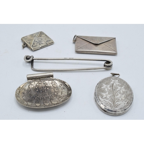 397 - A collection of silver items to include a stamp case, a smaller example, an oval locket, a clip and ... 