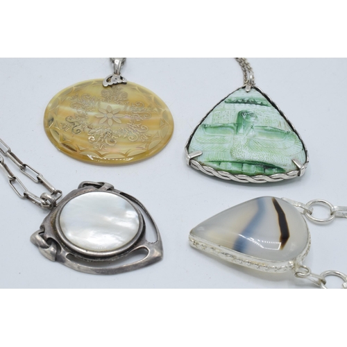 402 - A collection of silver necklaces with large pendants made from various materials (4).