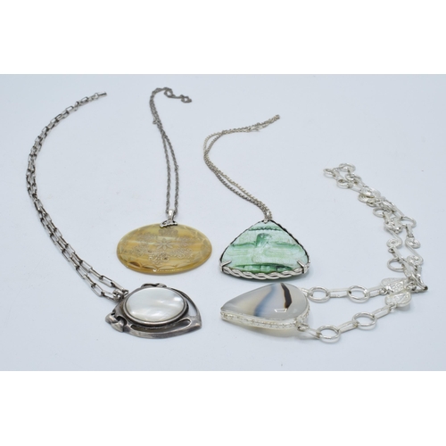 402 - A collection of silver necklaces with large pendants made from various materials (4).