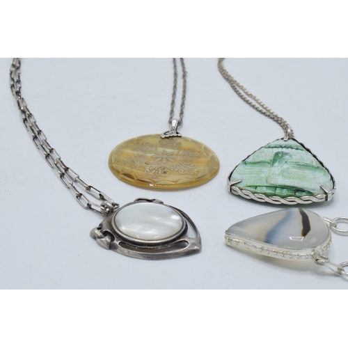 402 - A collection of silver necklaces with large pendants made from various materials (4).