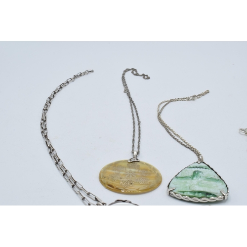 402 - A collection of silver necklaces with large pendants made from various materials (4).