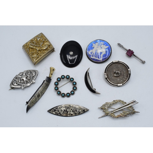 404 - A collection of silver brooches to include a silver gilt Indian brooch, a Scandinavian examples and ... 