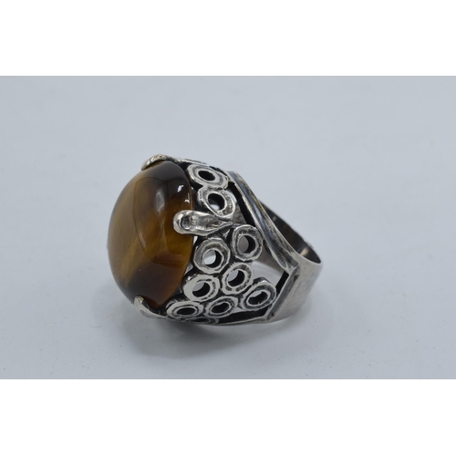 405 - Silver chunky ornate ring set with large tiger's eye together with a modernist similar example (2).