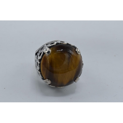 405 - Silver chunky ornate ring set with large tiger's eye together with a modernist similar example (2).