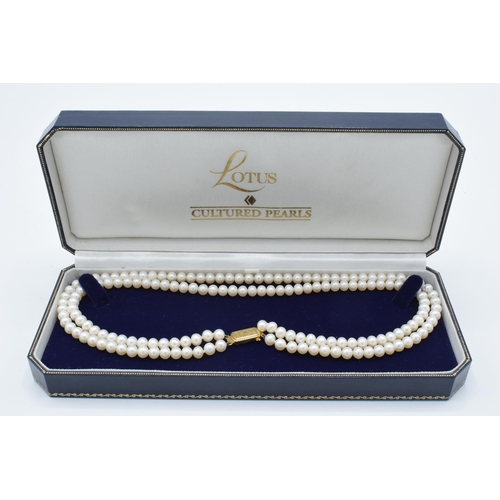 407 - Lotus cultured pearl double strand necklace with 9ct gold clasp, 42cm long, in original box.