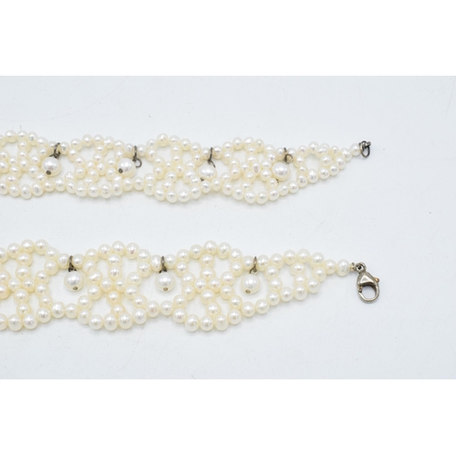 408 - A pair of silver mounted pearl bracelets, 19.5cm long (2).