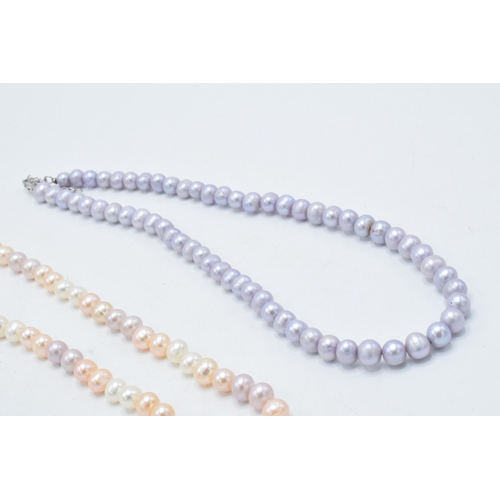 416 - A collection of 4 faux pearl necklaces of varying colours (4).