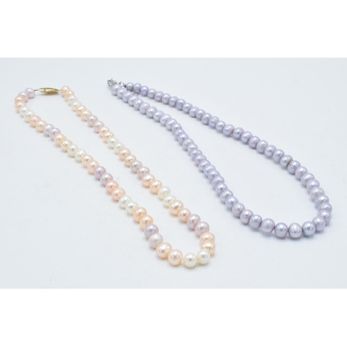 416 - A collection of 4 faux pearl necklaces of varying colours (4).